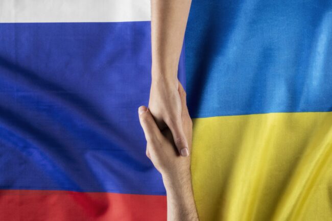 flat-lay-people-holding-hands-with-flags